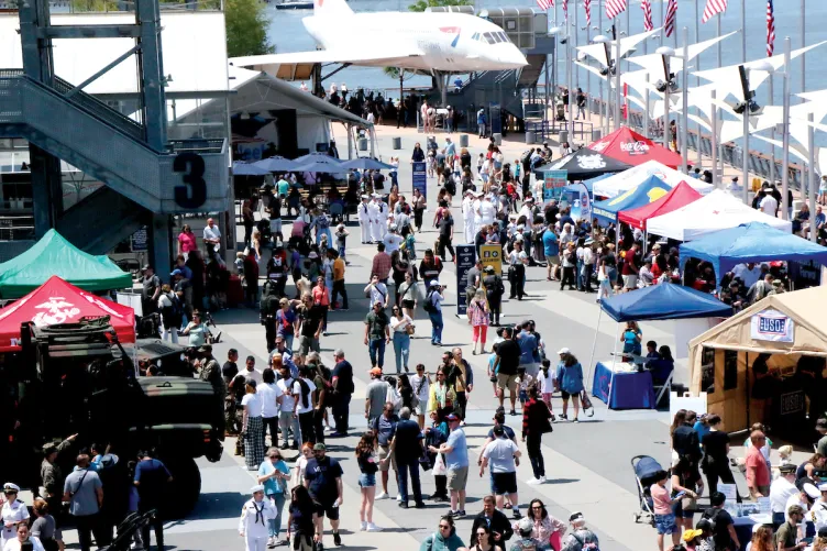 Crowds of people are on Pier 86, enjoying Fleet Week 2023