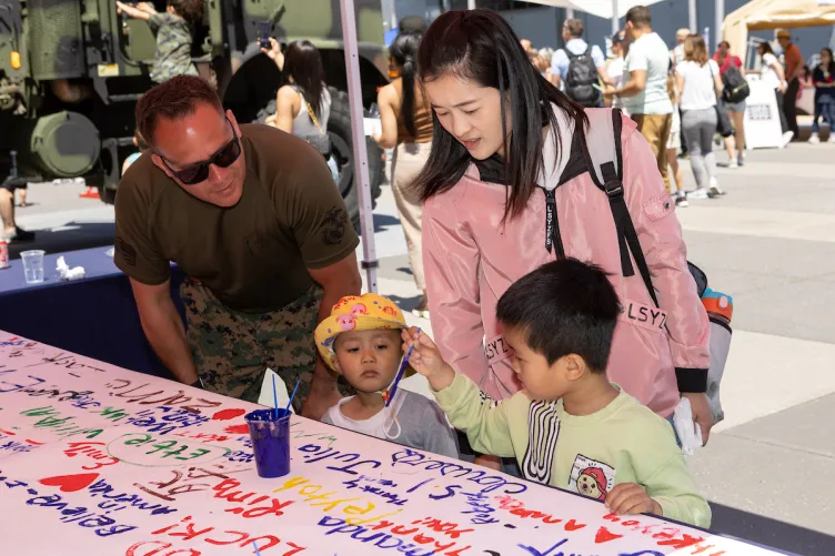 A family enjoying interactive activities on Pier 86 during Fleet Week.