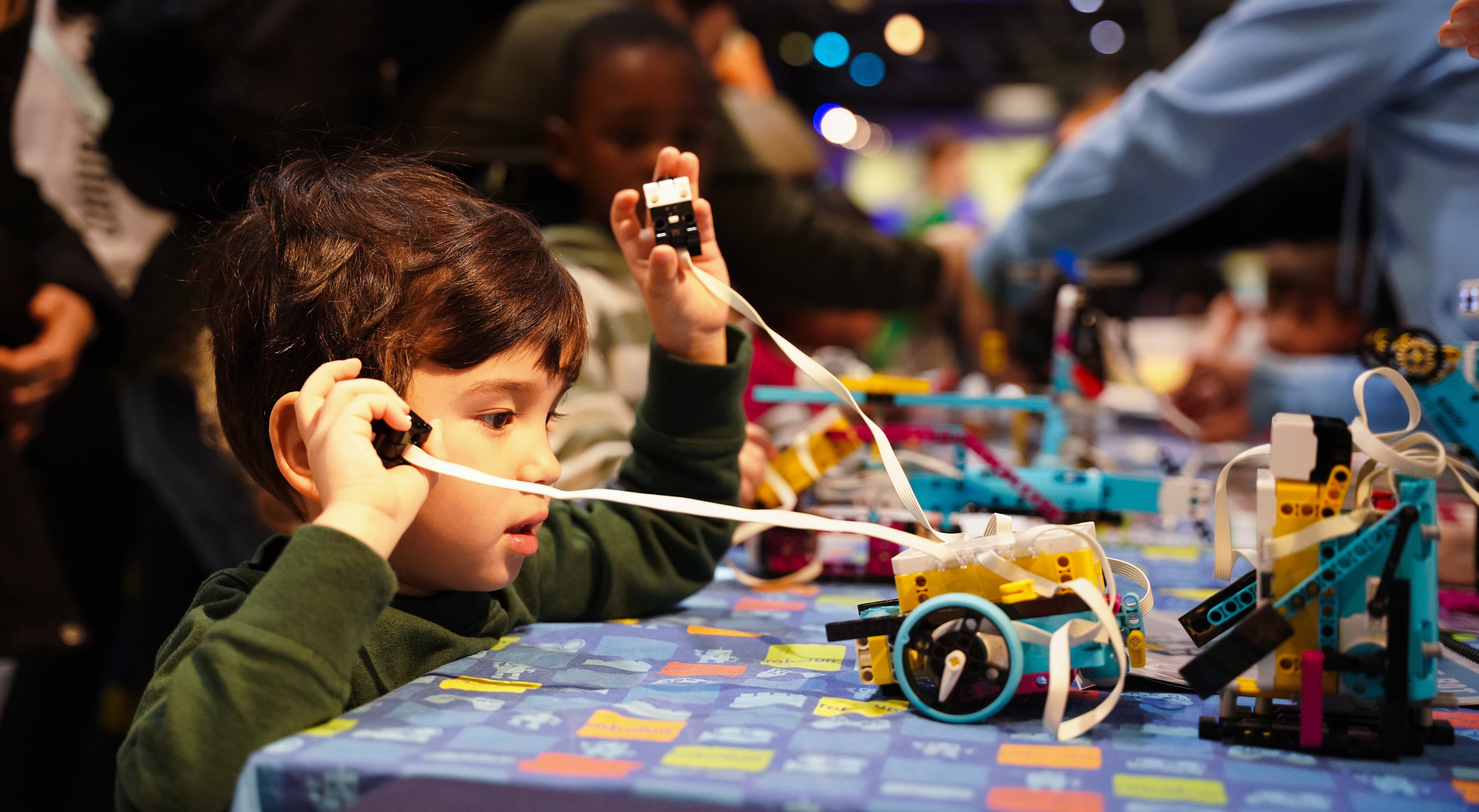 A kid enjoying a STEAM activity abroad Intrepid during Kids Week