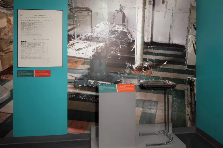 Exhibition panel and a tray of medical tools for visitors to interact with.