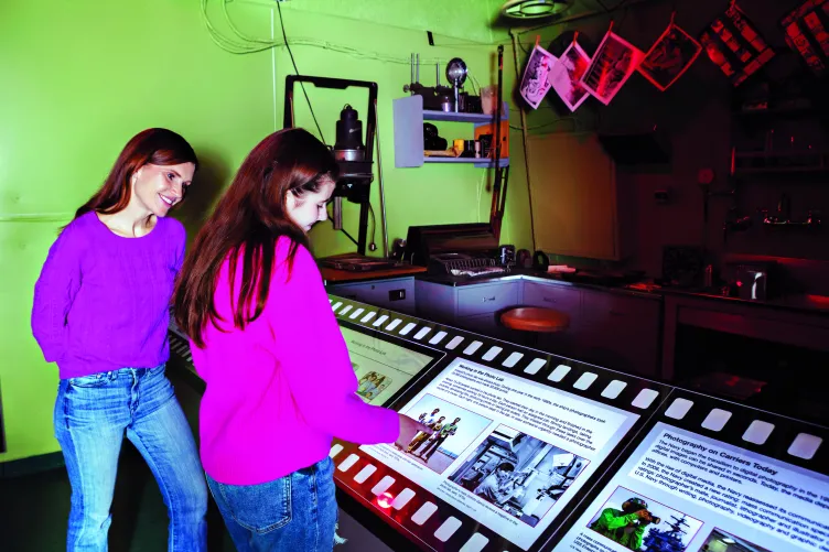 A mother and her teenage daughter explore the Museum&#039;s photo lab exhibition