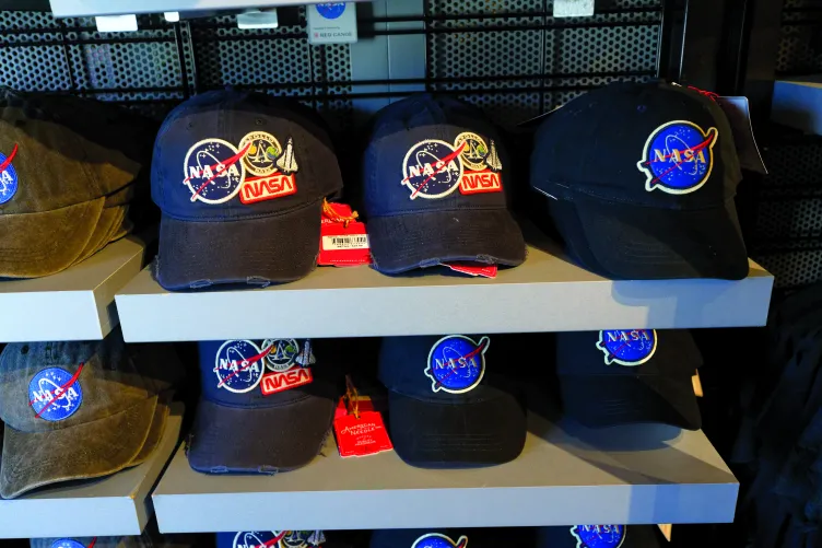 A collection of hats with the NASA logo on them available for purchase.