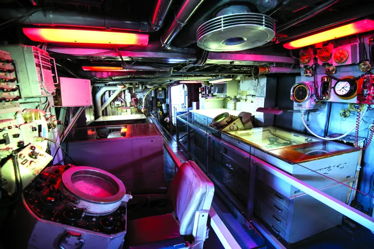  A pathway in the Growler which shows several control panels.