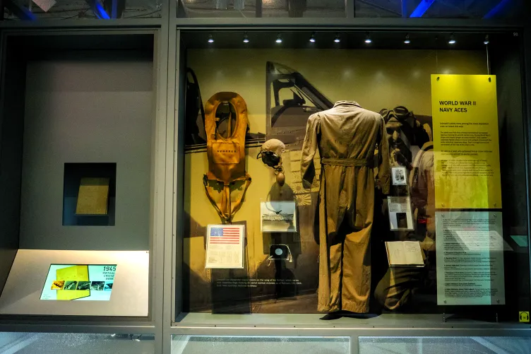 A display case featuring various artifacts, including a uniform