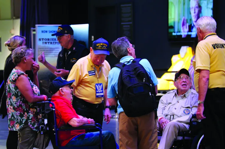 Veterans are speaking with several guests at the Museum.