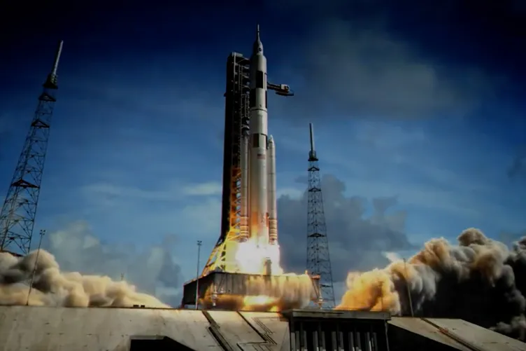 A rocket is blasting off with a blue sky in the background.