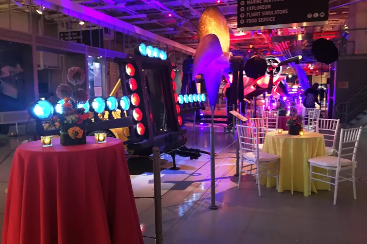 Hangar 1 set up with round tables and chairs for a reception