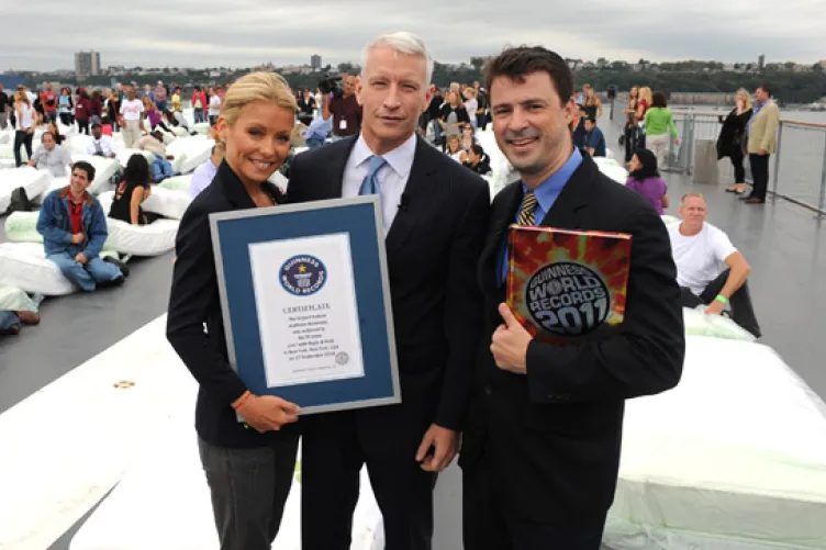 Stuart Claxton from Guinness presents Kelly and Anderson with the official Guinness World Record certificate. Photo credit: Disney-ABC Domestic Television