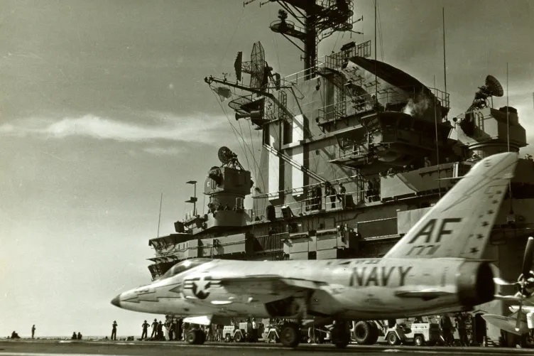 An archival photo of the Intrepid&#039;s flight deck with a navy plane on it, about to take off.