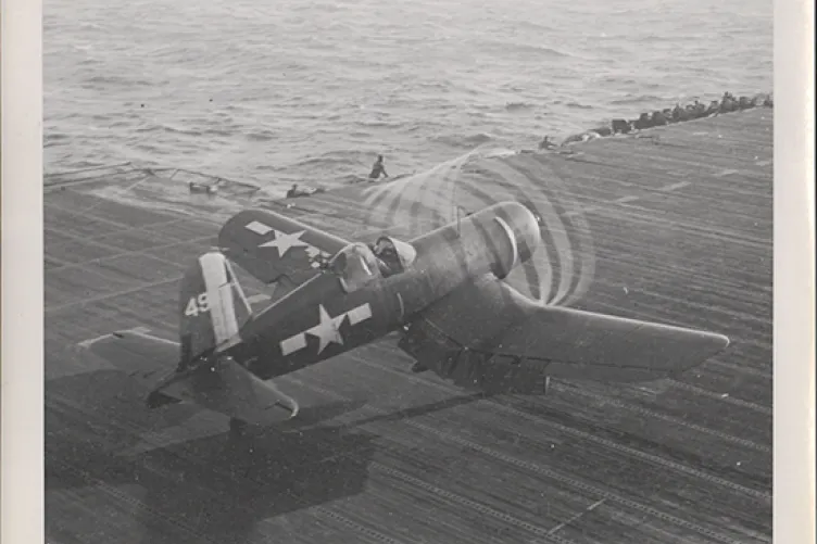 an old image of an aircraft sitting on the flight deck of the uss intrepid