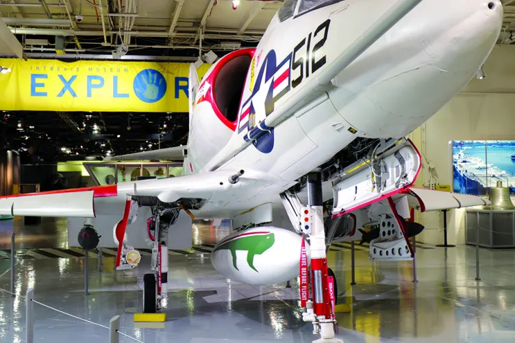 A large plane on the hangar deck with the Exploreum sign in the background.