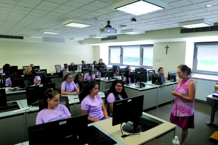 A group of Goals for Girls in a classroom with computers