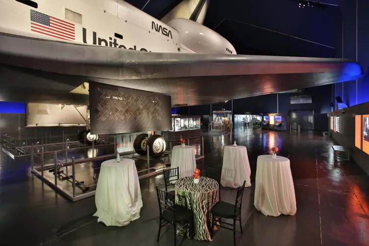 Cocktail tables set up in the Space Shuttle Pavilion for an event