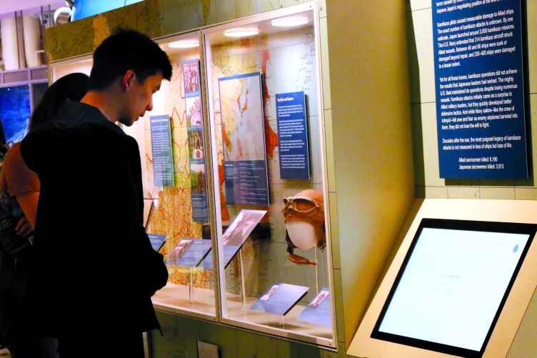 Visitors reading an exhibition panel