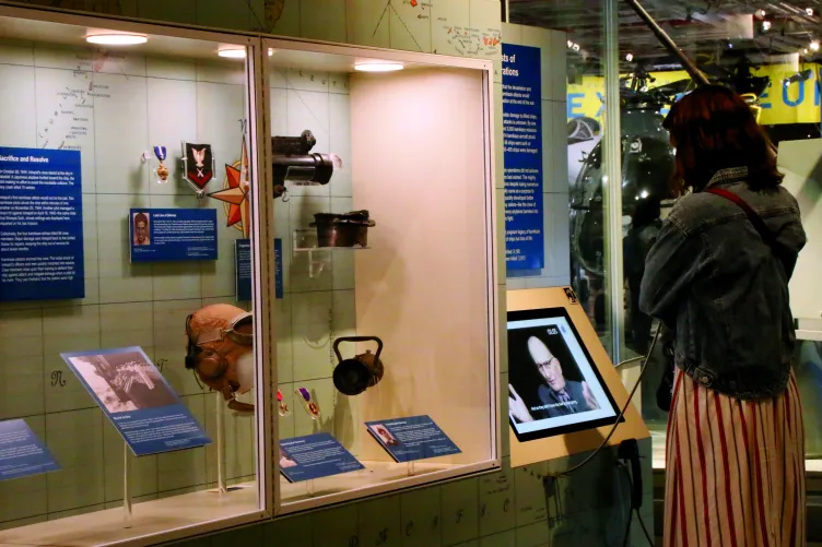 A visitor listening to an audio component of the exhibition