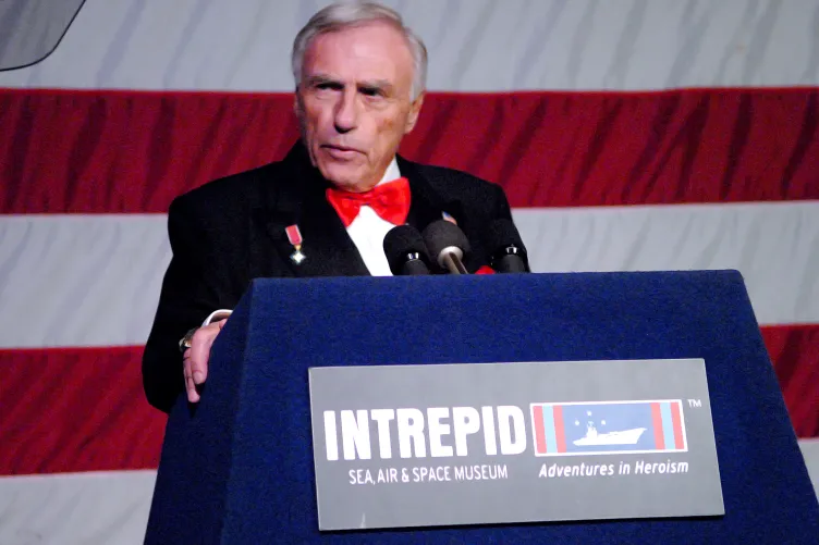 Arnold Fisher, the former chairman of the intrepid museum giving a speech