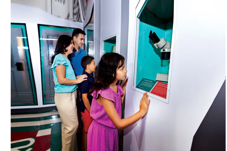 Family explores exhibition cases at On the Mend Exhibition