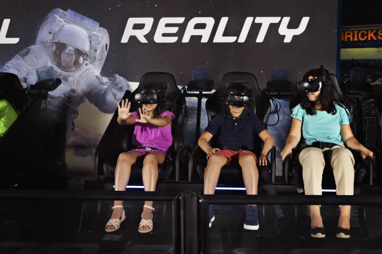 Kids enjoying a ride on the Apollo 11 &amp; Beyond Virtual Reality Simulator