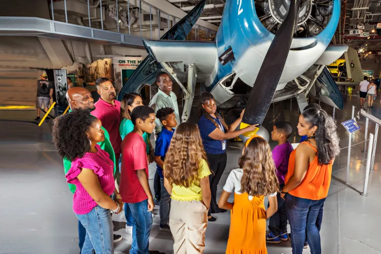 Group of visitors with a museum guide in front of the Avenger