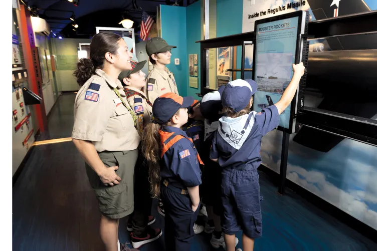 A group of Boy Scouts explore A View from the Deep exhibition
