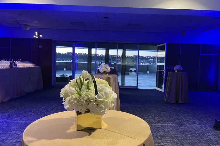 VIP Room setup with tables and floral arrangements and blue ambience lighting