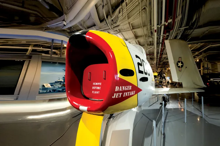 Red and Yellow FJ-3 Fury Aircraft display at the hangar deck