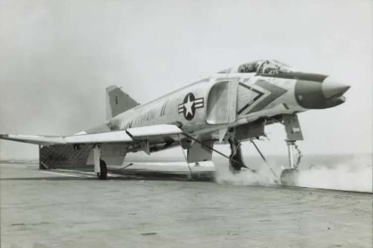 A jet plane sits on the flight deck, ready to be launched.