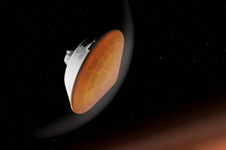 A round spacecraft against a starry sky, approaching an orange mass. The bottom of the spacecraft is orange and surrounded by a white semicircle.