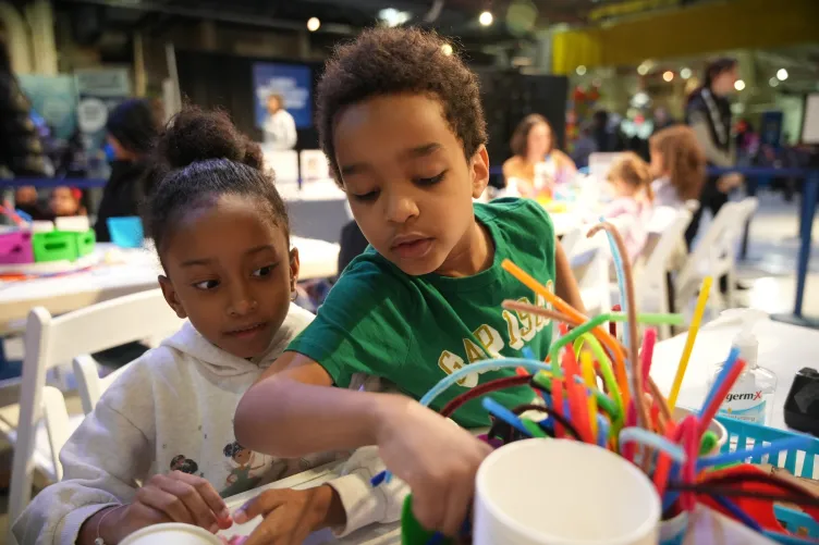 Two children engaged in an arts and crafts activity.