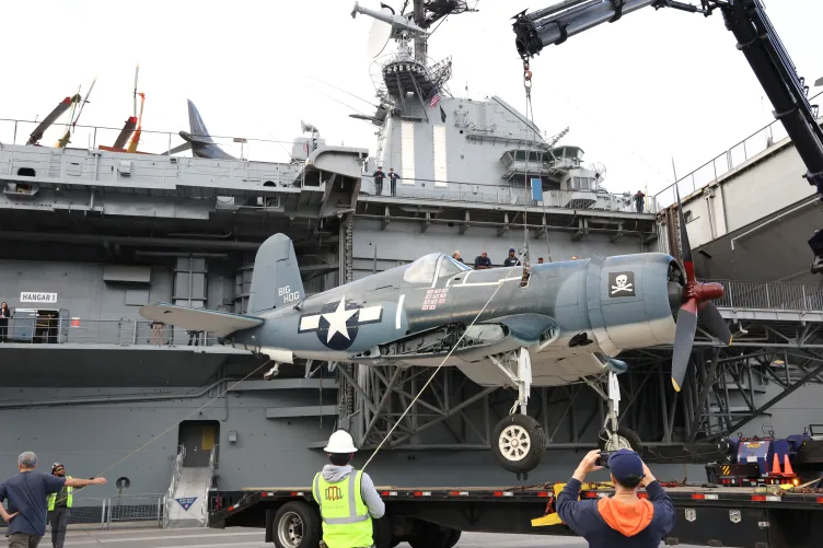 Corsair aircraft suspended on a crane at Pier 86, Intrepid Museum