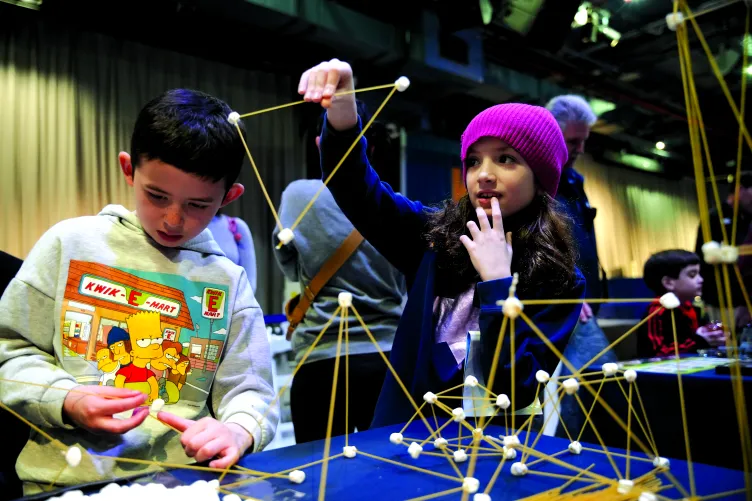 Two children participating in an interactive activity during Kids Week.