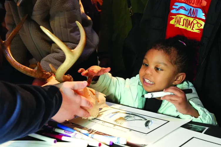 Two children participating in an interactive activity during Kids Week.