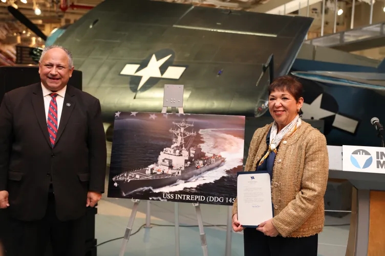 Mr. and Mrs. Del Toro  stand together on the hangar deck of the Intrepid Museum.