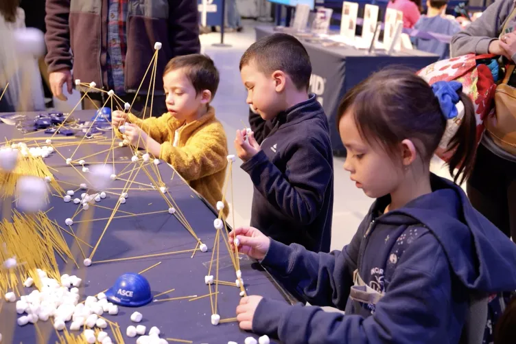 Children interacting with an activity during Kids Week.