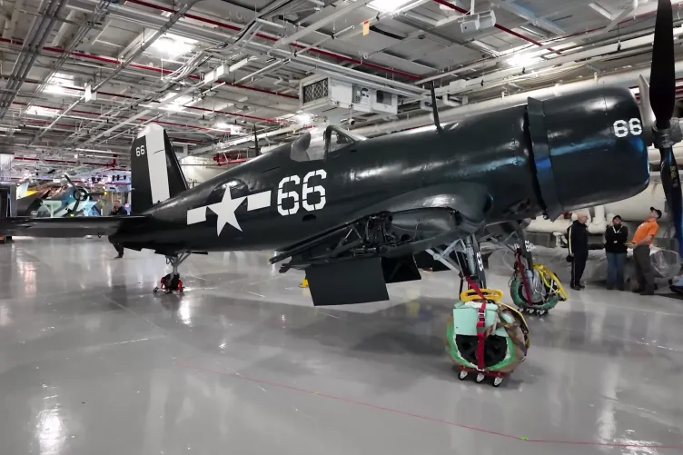 Corsair aircraft inside the Intrepid Museum's hangar deck being moved into its permanent exhibition spot.