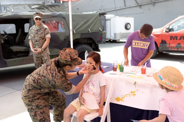 Visitors participating in Fleet Week activities on Pier 86 at the Intrepid Museum