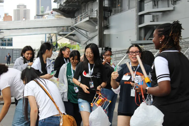A group of young students engaged in hands-on STEM activities during Space Day at the Intrepid Museum.