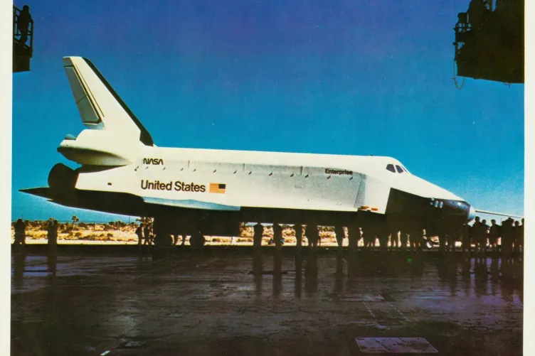 Space Shuttle Enterprise with a crowd of people taking pictures. 