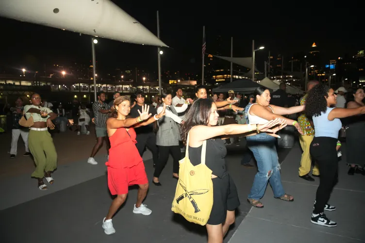 A group of people doing the Macarena.