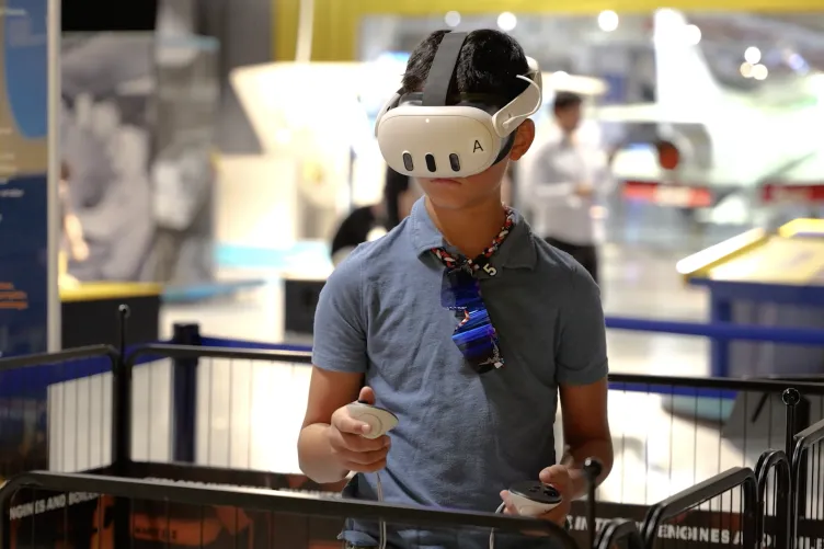 Guest explores the Intrepid's engine room through an immersive VR experience