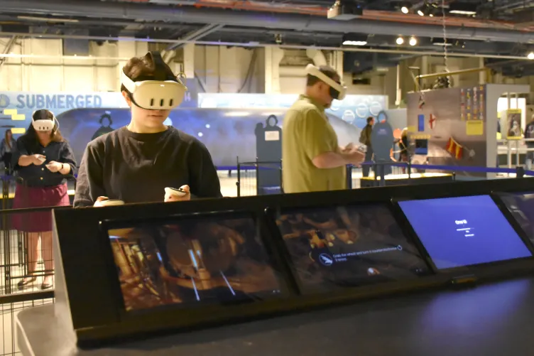 Several people enjoying Intrepid's VR experiences on board.