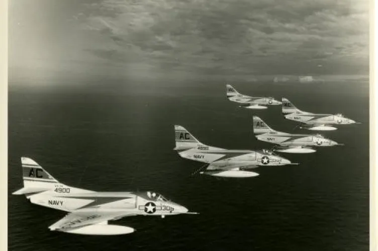 Black and white photo of five Navy jet planes flying in formation.