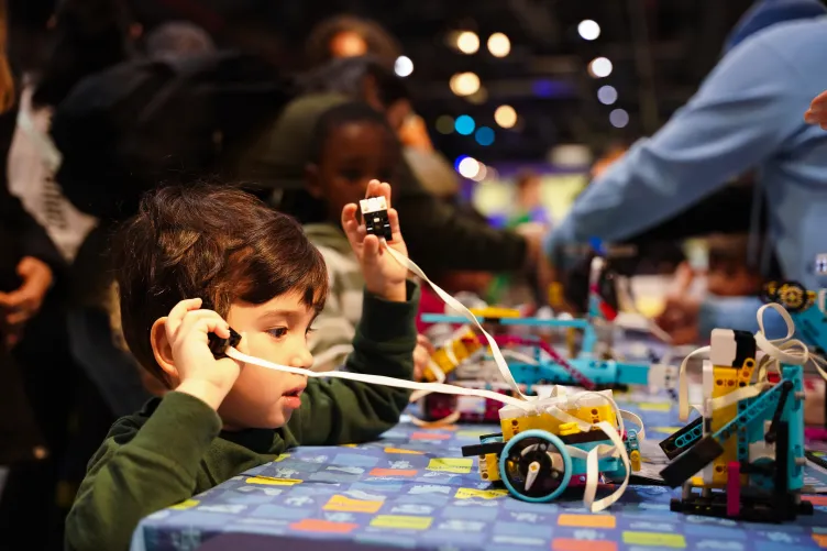 A kid enjoying an interactive STEAM activity aboard Intrepid during Kids Week