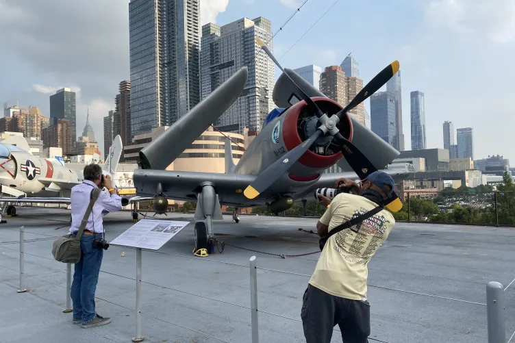 Patrons taking photos of aircraft on Intrepid's flight deck.