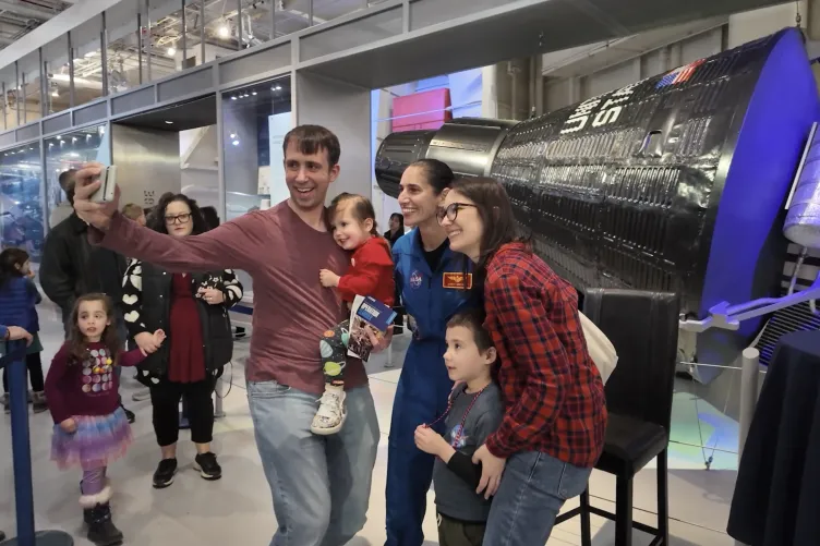 NASA Astronaut Jasmin Moghbeli posing for picture with kids and parents
