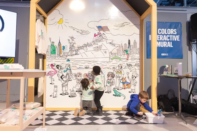 Kids coloring a mural onboard Intrepid during Kids Week
