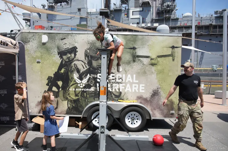 Children participating in interactive activities with the military during Fleet Week