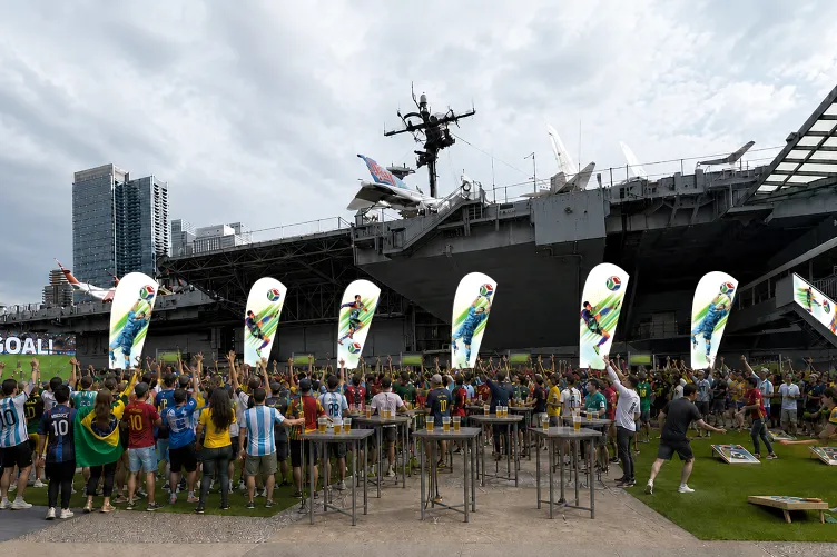 Illustration of people gathered on Pier 86 cheering and watching a soccer match