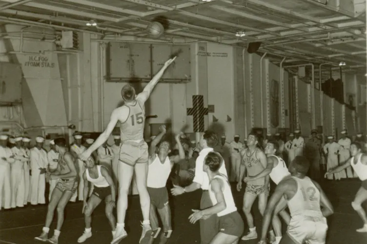 A basketball game on the hangar deck between Intrepid sailors and locals from Lisbon, Portugal, 1958.