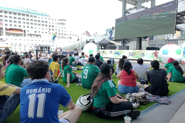 Group of people of all ages watching the world cup on pier 86